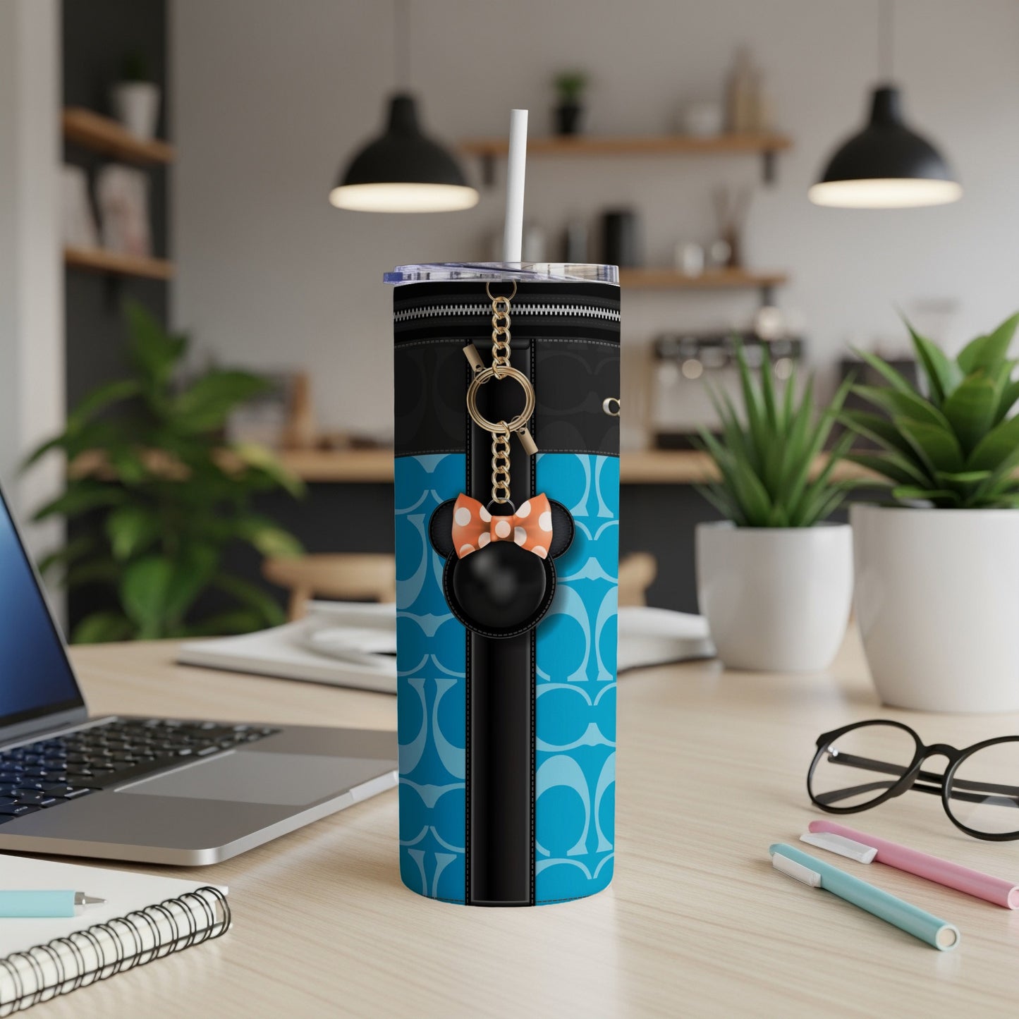Tumbler with Minnie Mouse charm and blue patterned design featuring gold chain.