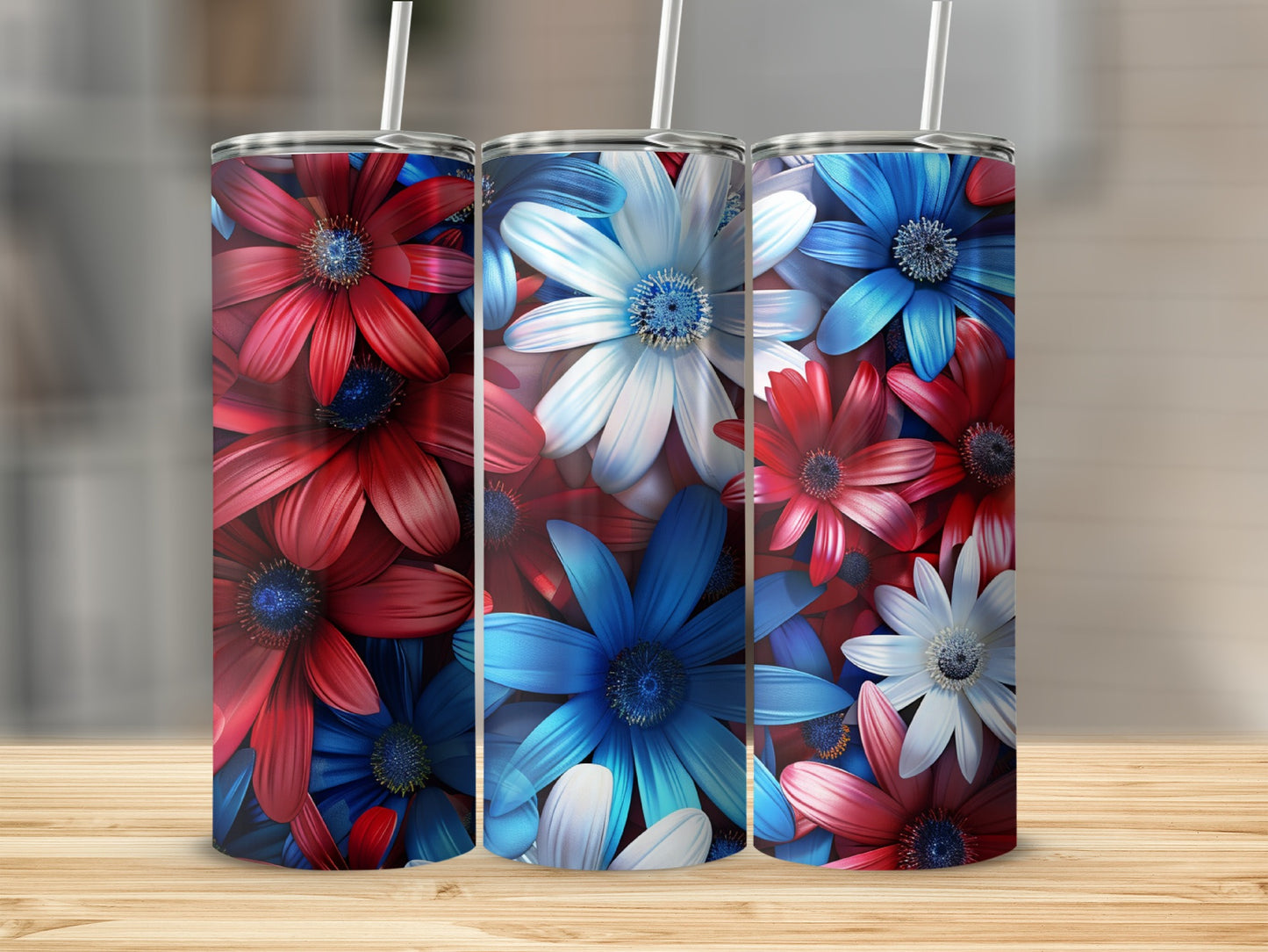 Three tumblers with red, white, and blue floral designs on a wooden surface.