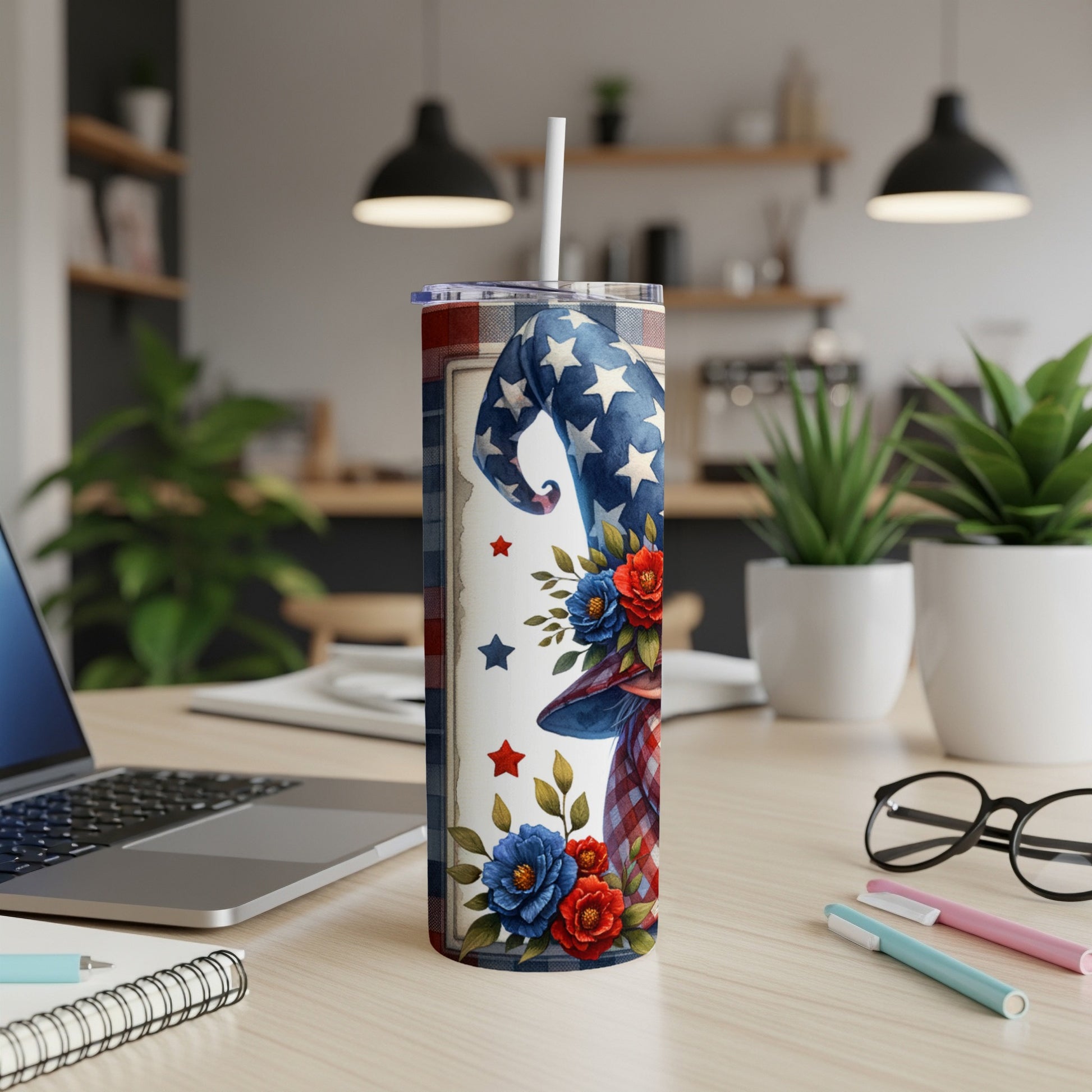 Patriotic tumbler with stars and flowers, standing on a desk.