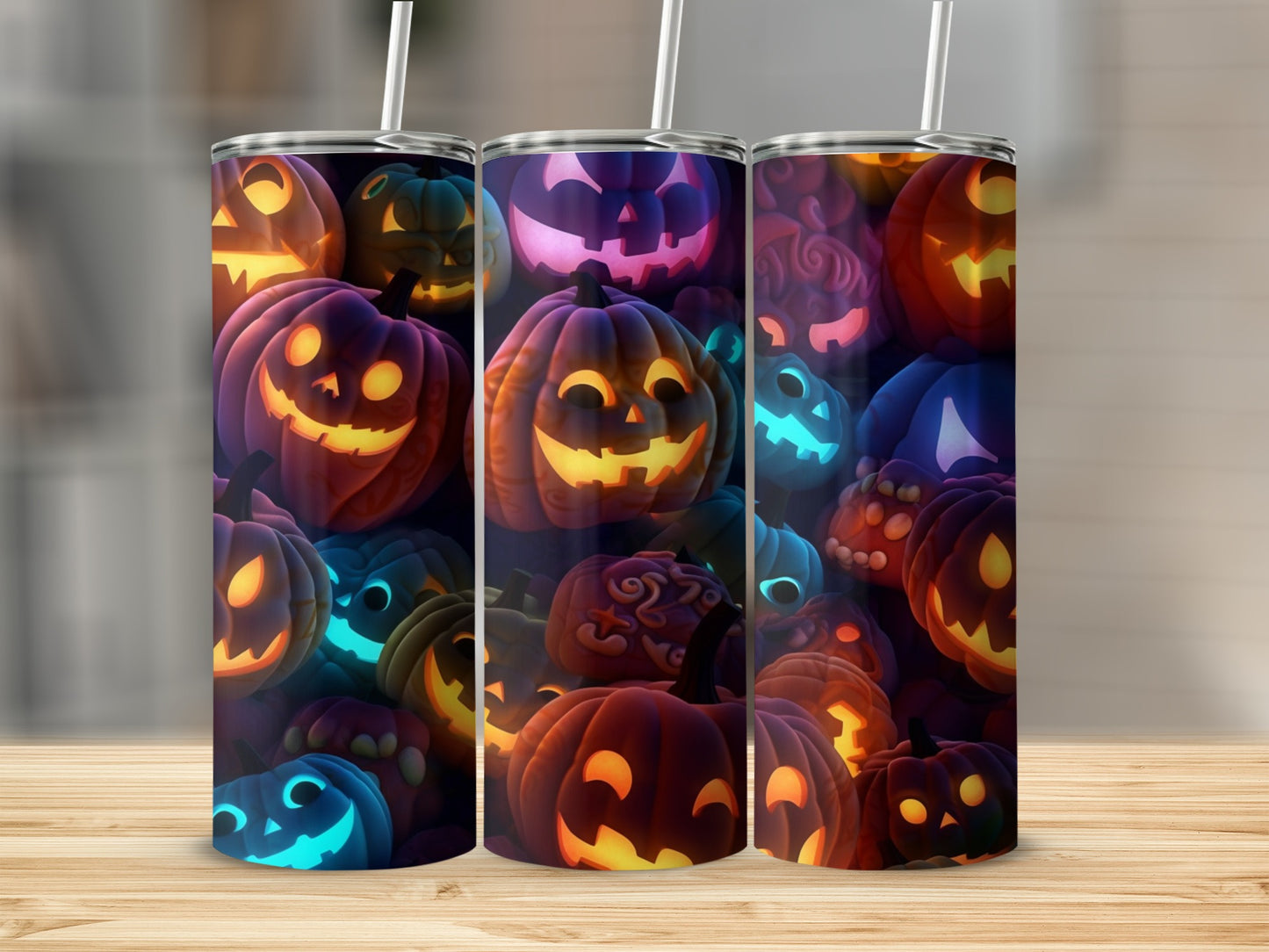 Three tumblers with glowing Halloween jack-o'-lantern patterns.