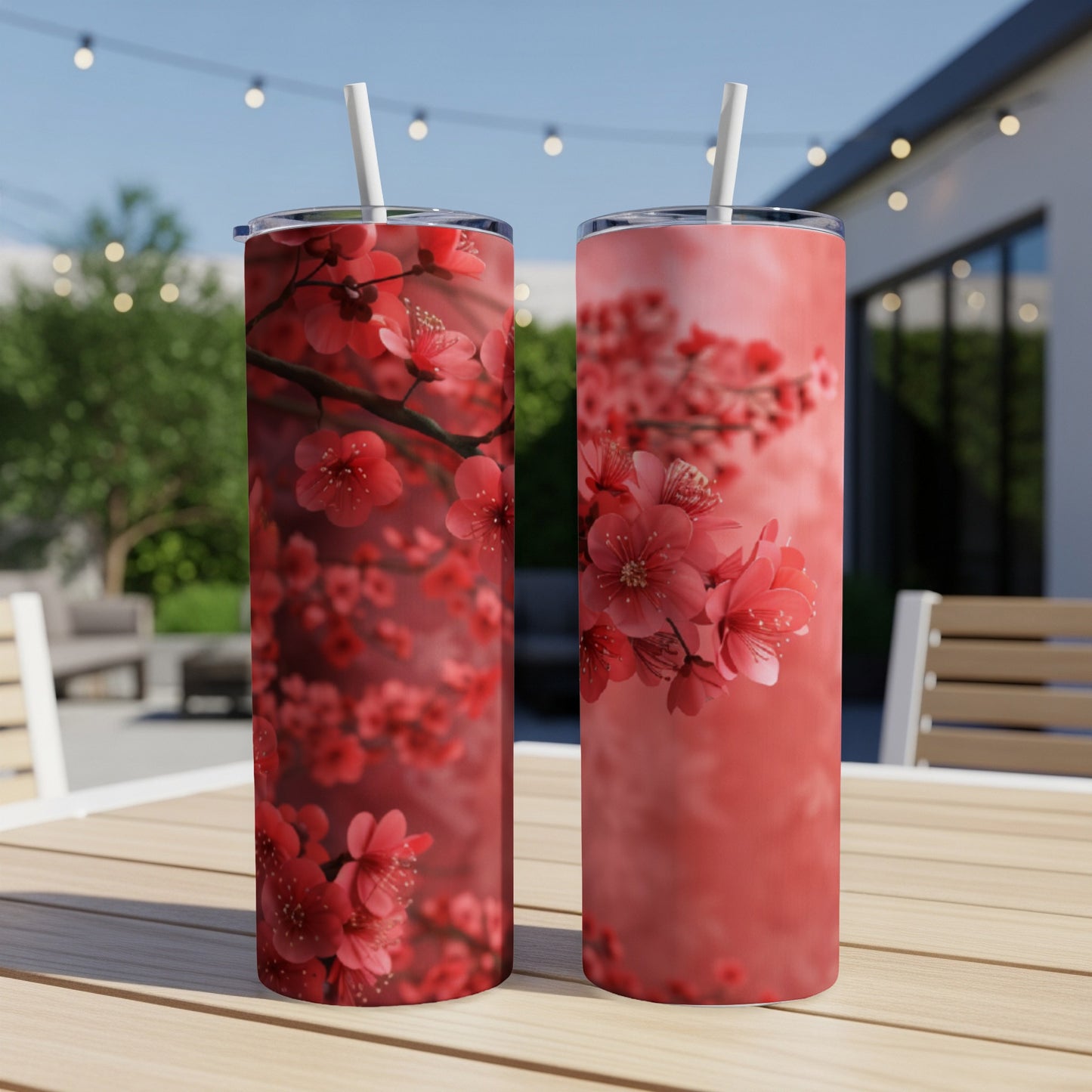 Two tumblers with vibrant pink cherry blossoms against a blurred outdoor background.