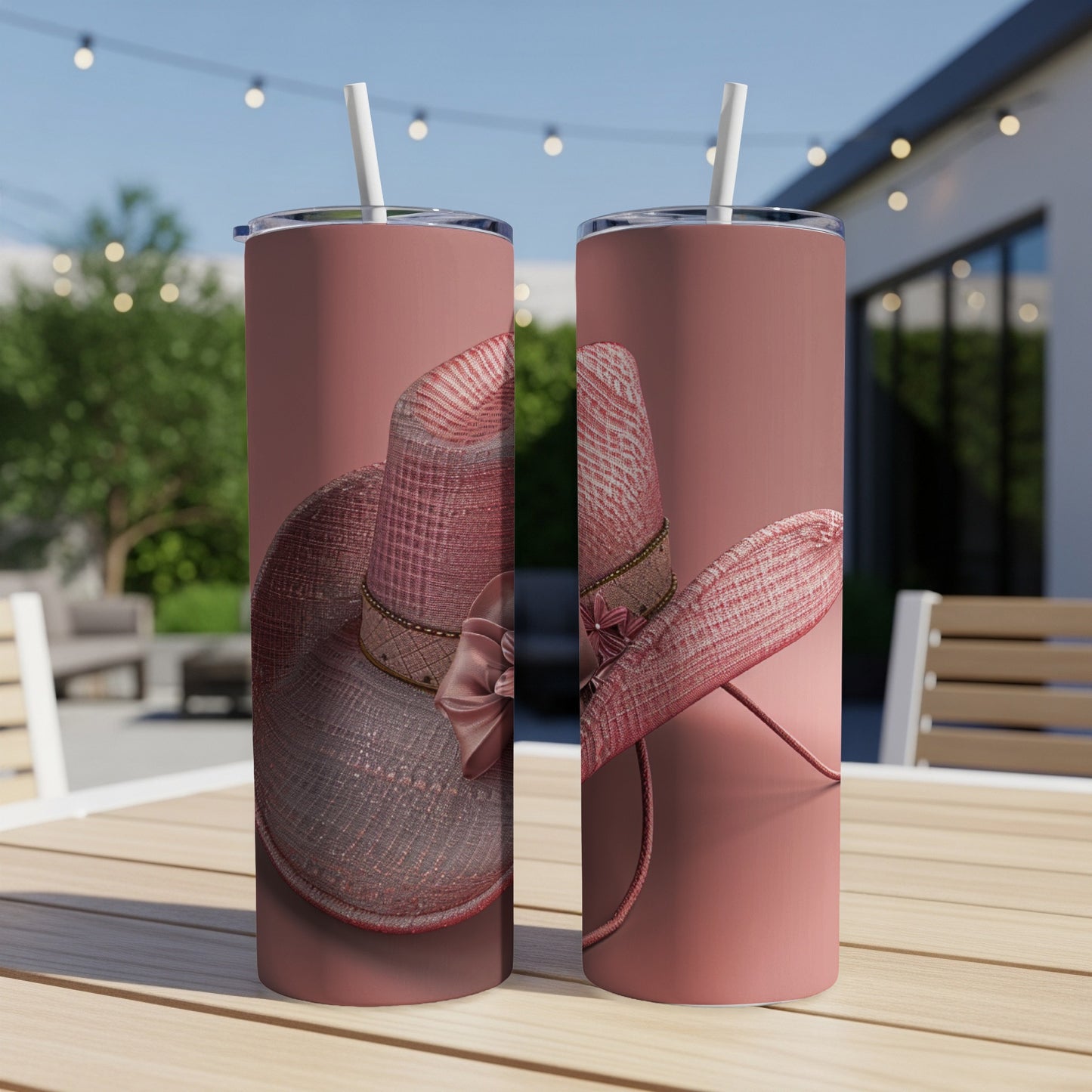 Two pink tumblers with a textured hat design and straw lids.