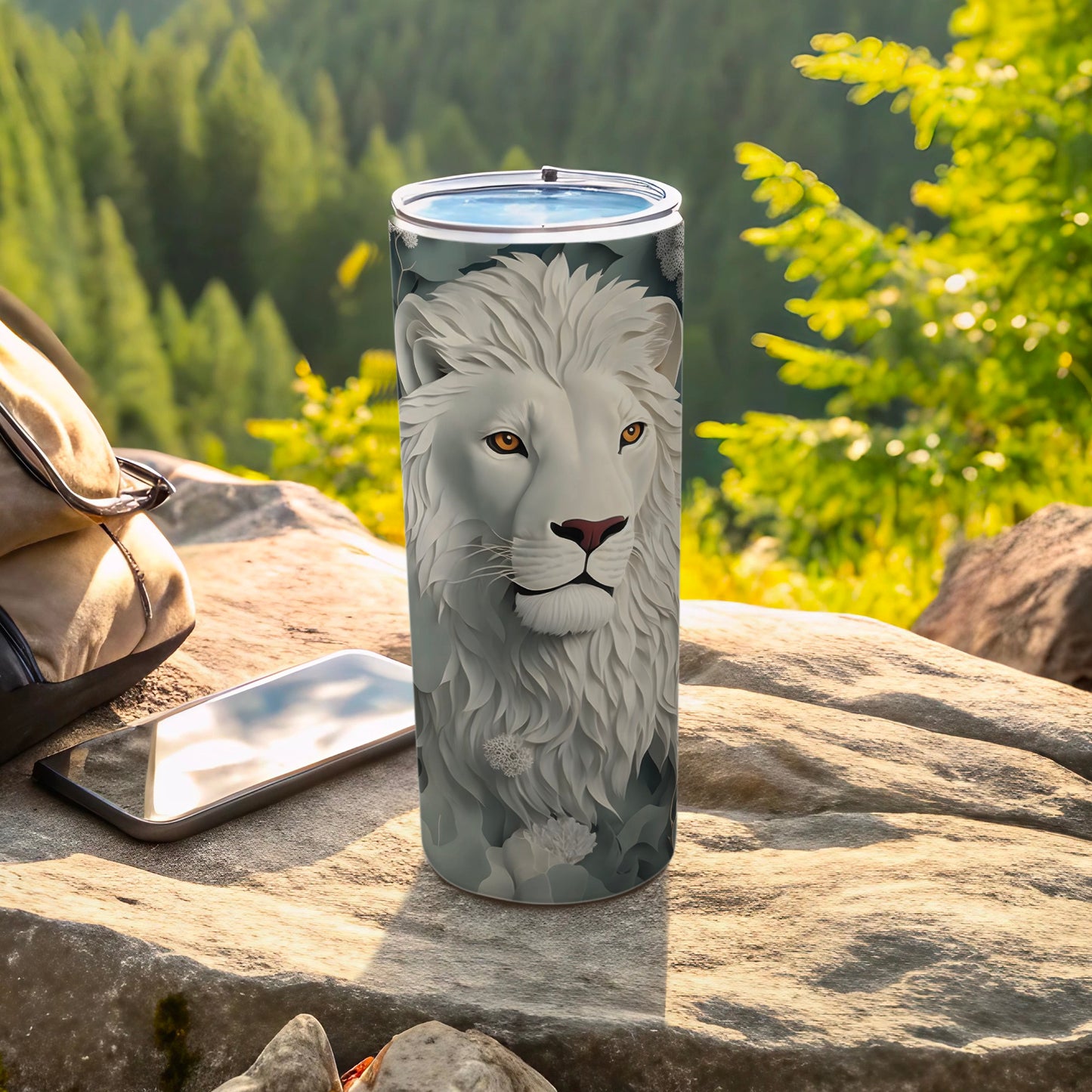 White lion head art on a tumbler, with a phone and backpack nearby.