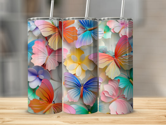 Tumblers with colorful butterfly and flower designs on a wooden surface.