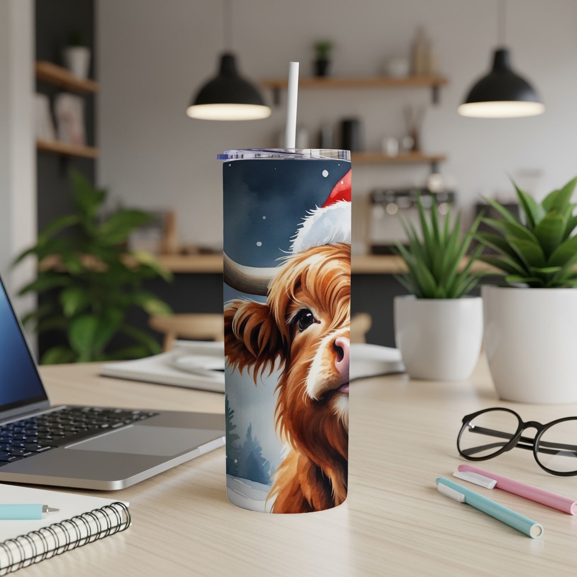Highland cow in Santa hat on a festive blue and white tumbler.