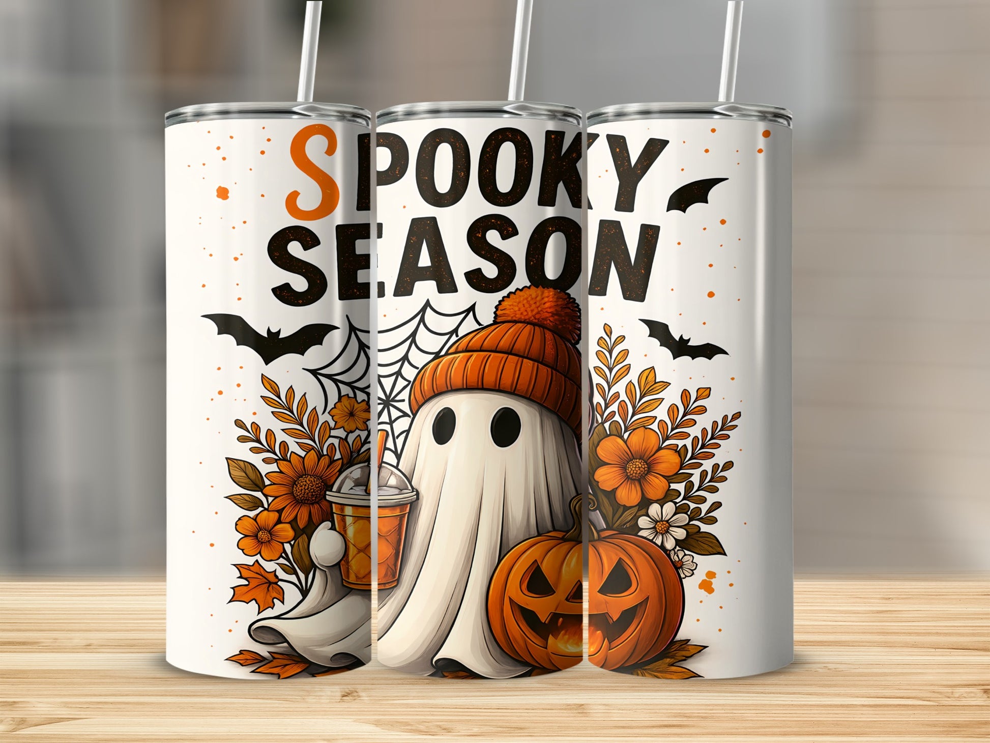 White tumblers with "Spooky Season" text, a ghost, pumpkin, and fall flowers.