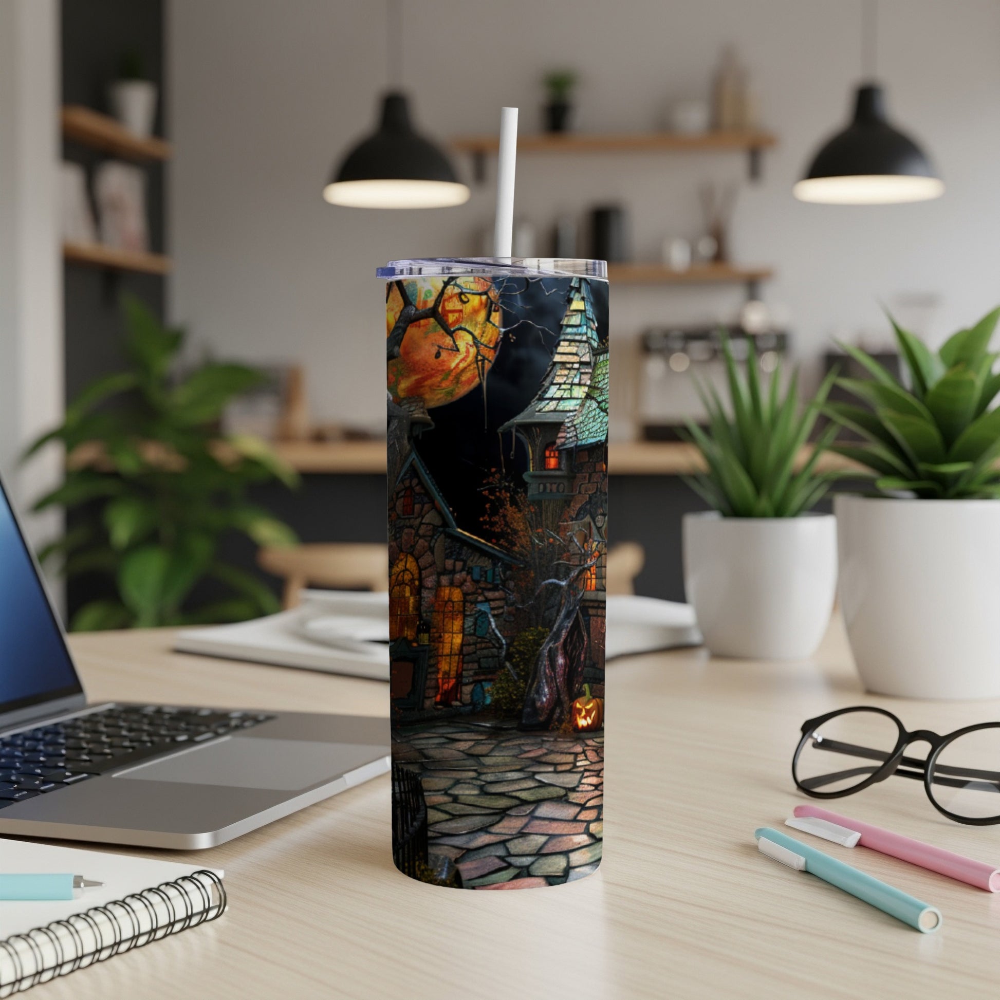 Halloween haunted house design on a white tumbler with a straw.