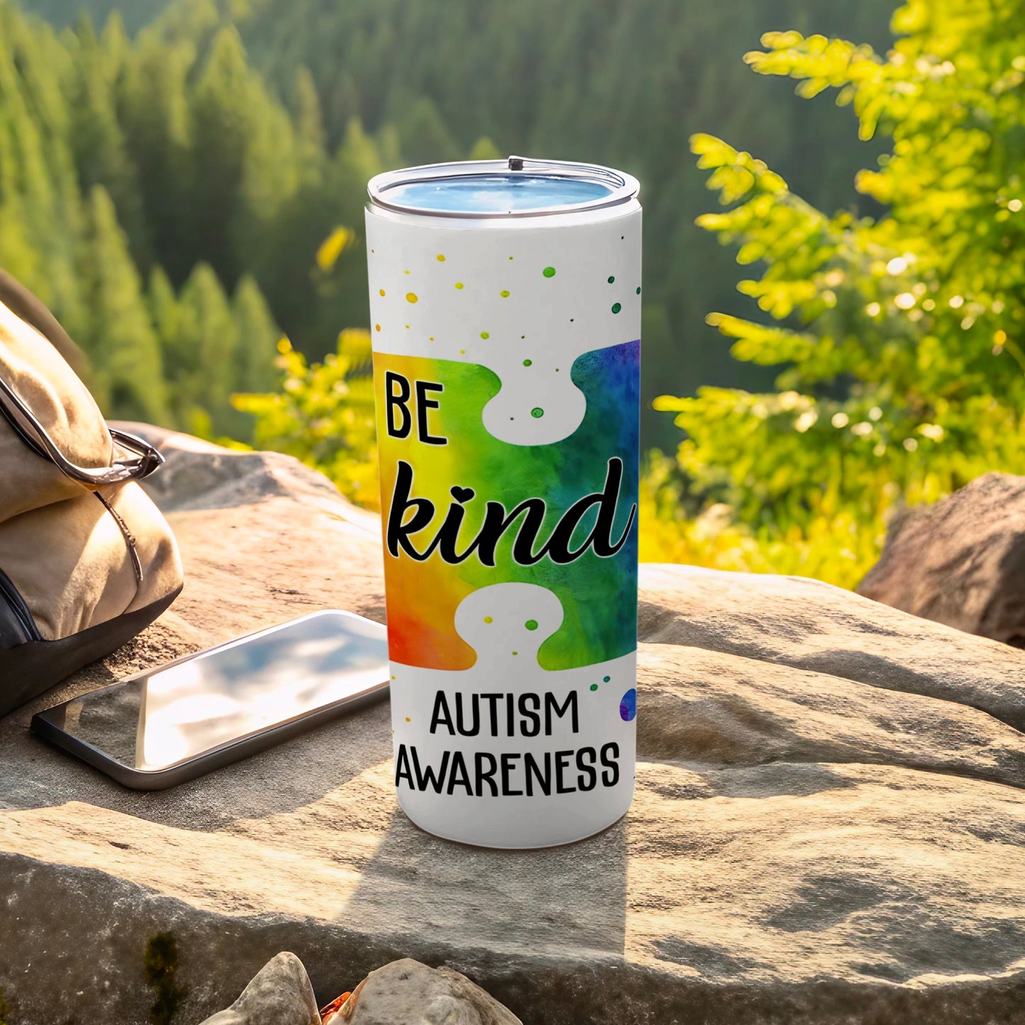 Tumbler with "BE KIND AUTISM AWARENESS" text on a puzzle piece design.