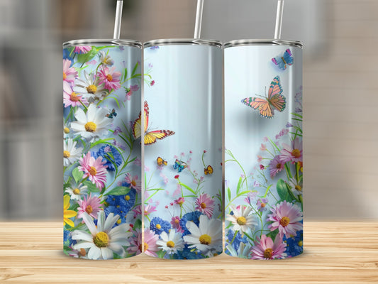 Three tumblers with a floral and butterfly design on a wooden surface.