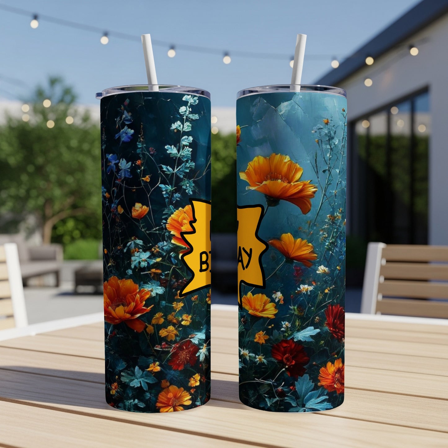 Two tumblers with floral designs and "Birthday" text against a blurred outdoor background.