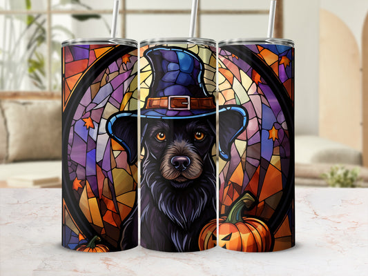 Black dog in a witch hat with pumpkins, stained glass background.