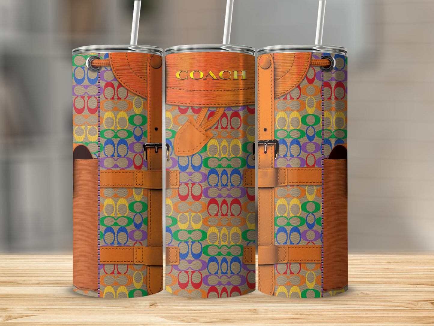 Three tumblers with Coach logo pattern in rainbow colors, featuring leather accents and straws.