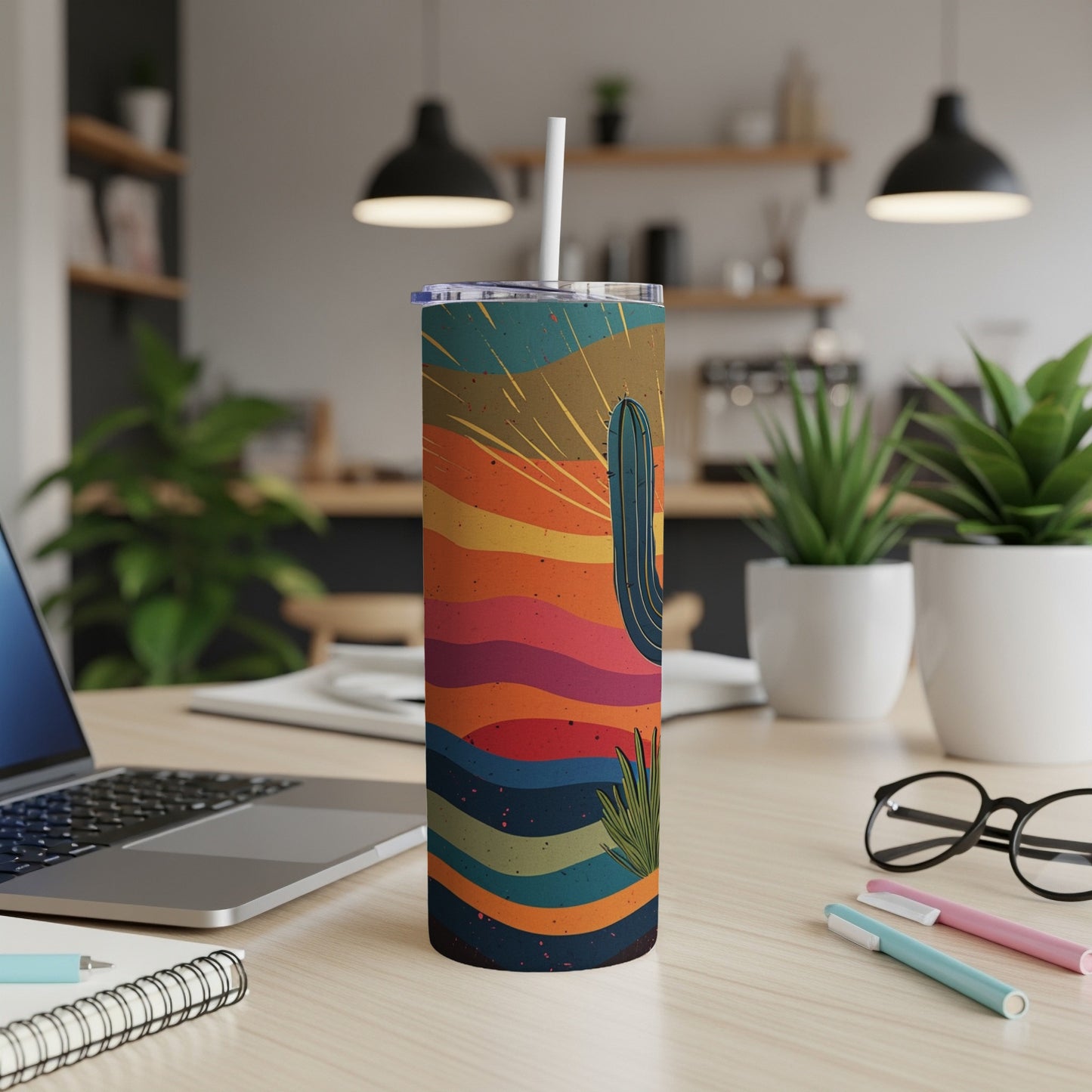 Desert sunset cactus tumbler with straw on desk.