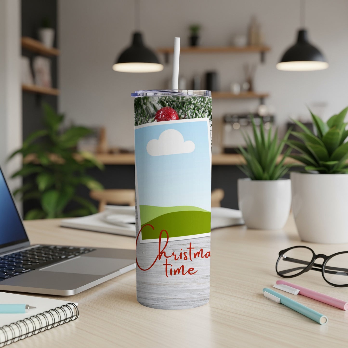 Tumbler with Christmas scene and "Christmas time" text on a desk.