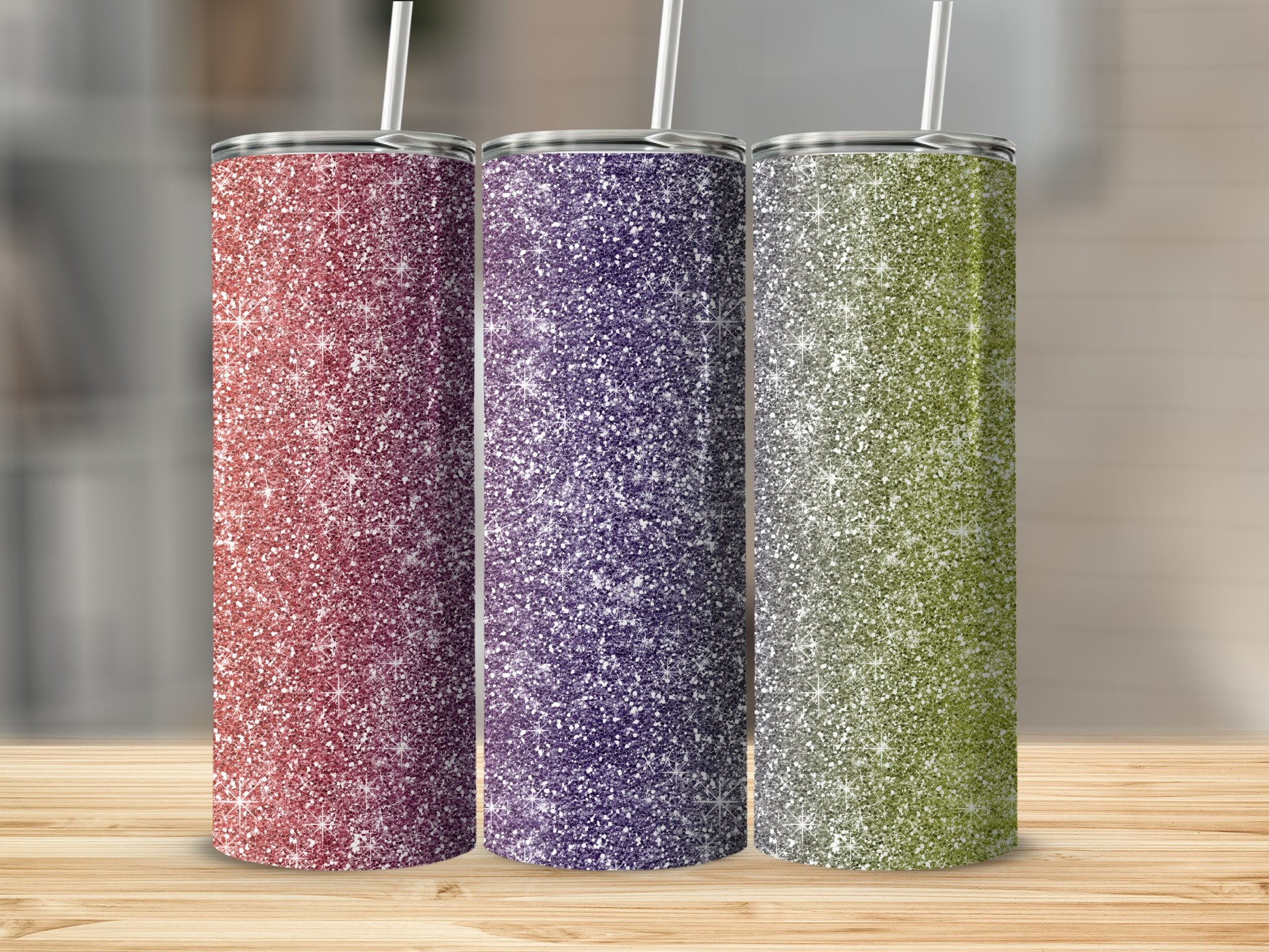 Three glitter tumblers in red, purple, and green with straws.