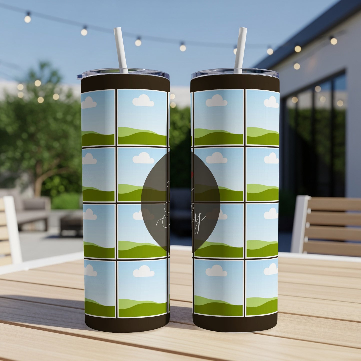 Two tumblers with landscape grid designs sit on a wooden table.