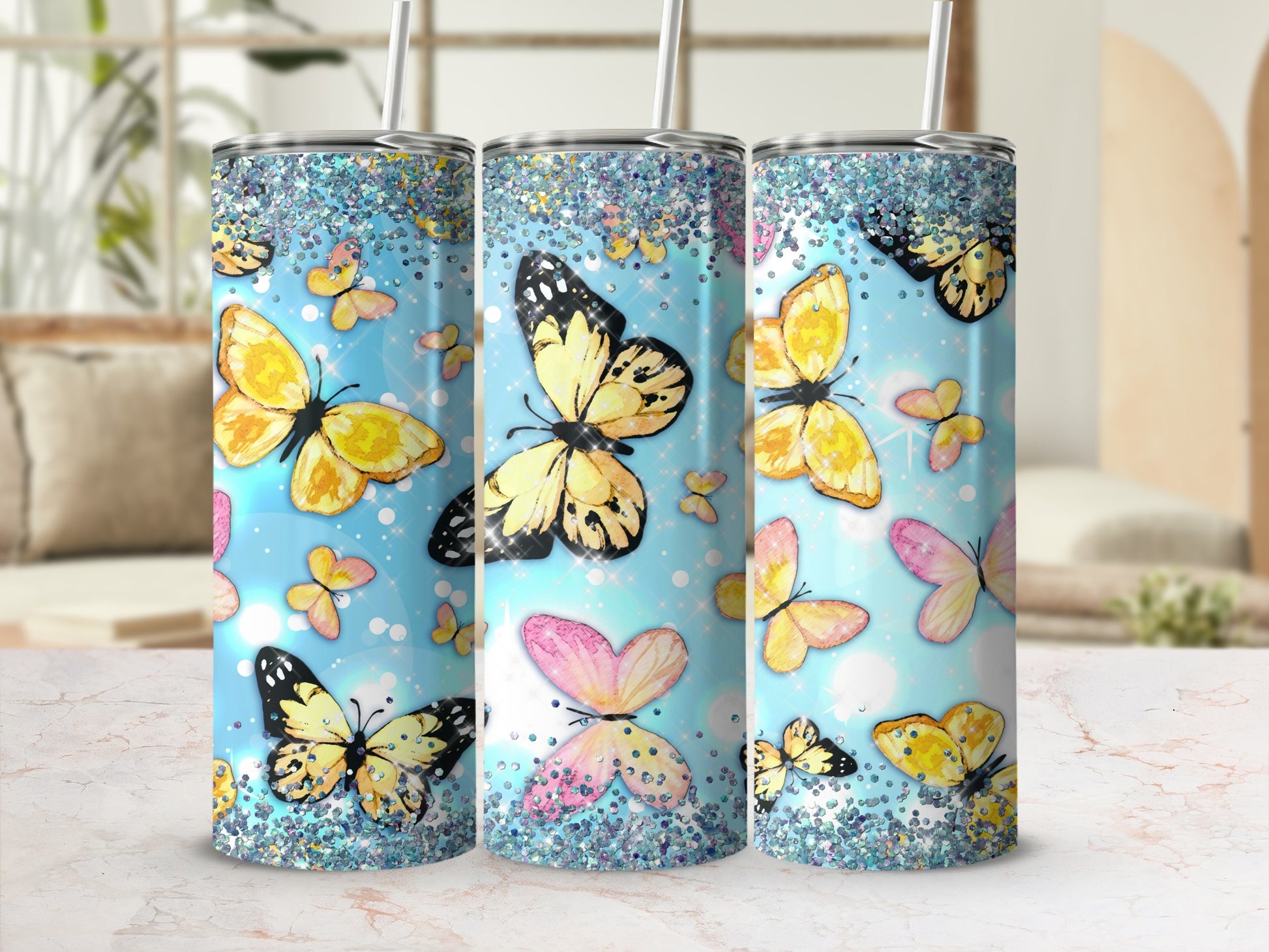Three tumblers with glittery tops and butterfly designs in light blue.