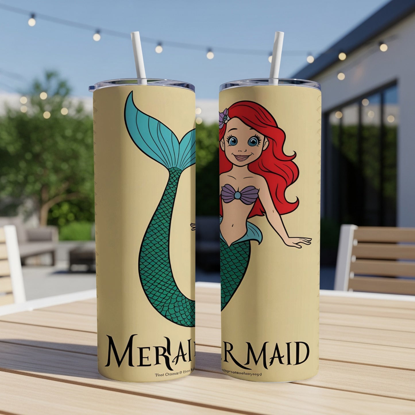 Mermaid character with red hair and green tail on a tan tumbler.