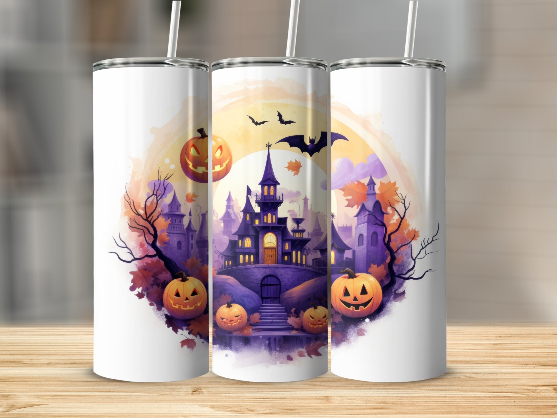 Three tumblers decorated with a Halloween scene of a spooky castle, pumpkins, and bats.