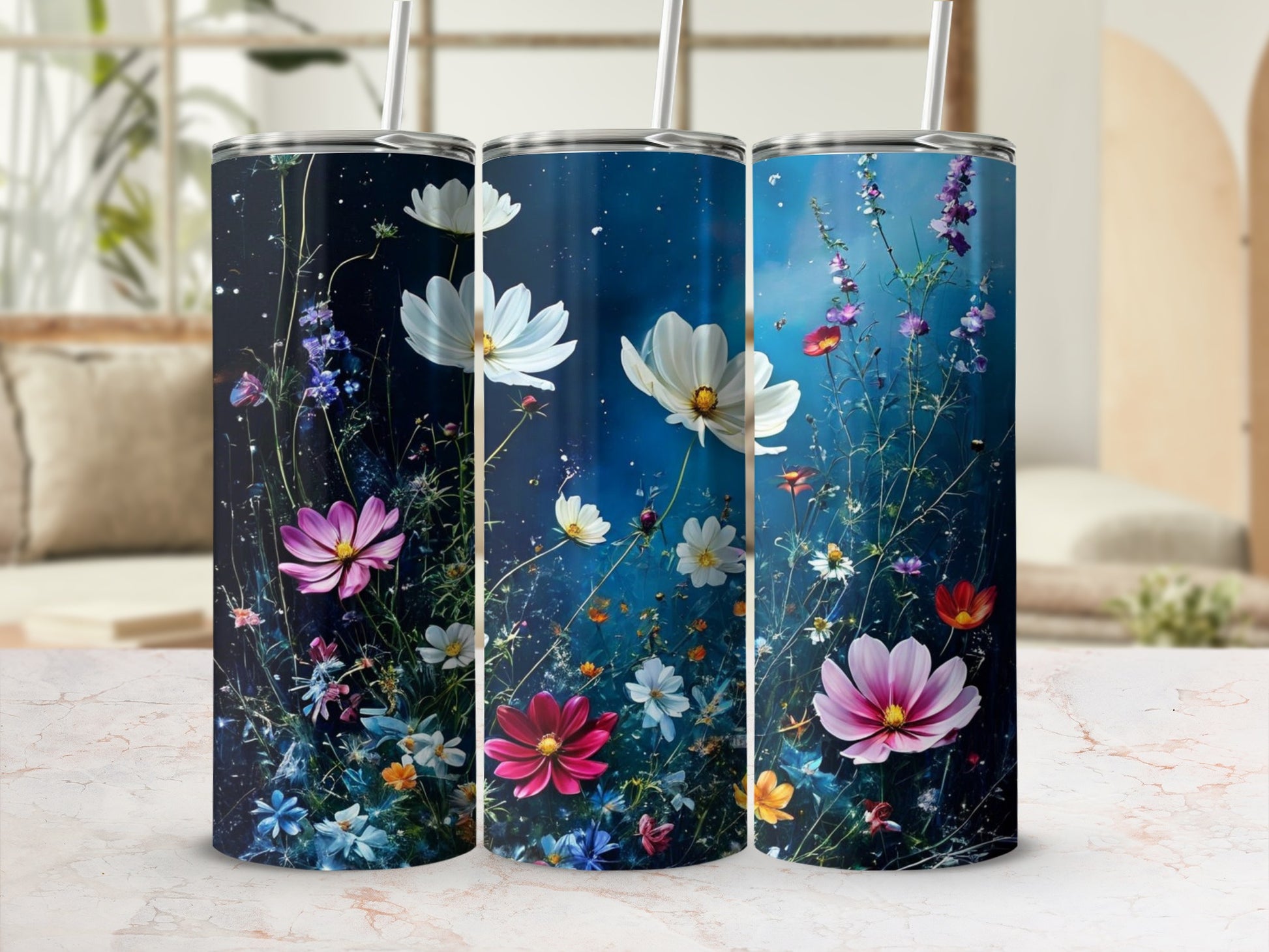 Three tumblers with a floral design on a blurred background.