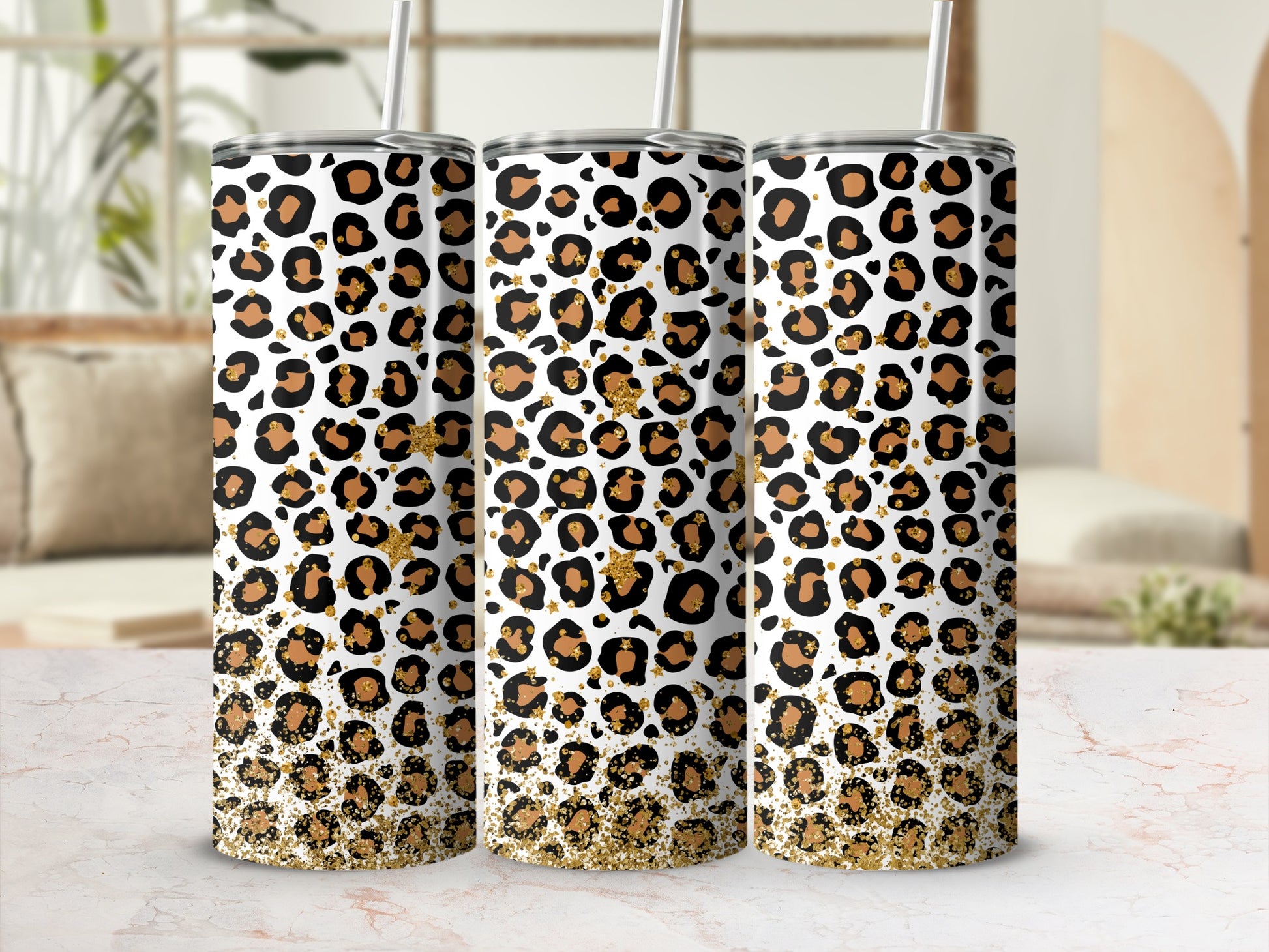Three tall tumblers with leopard print and gold glitter detail.