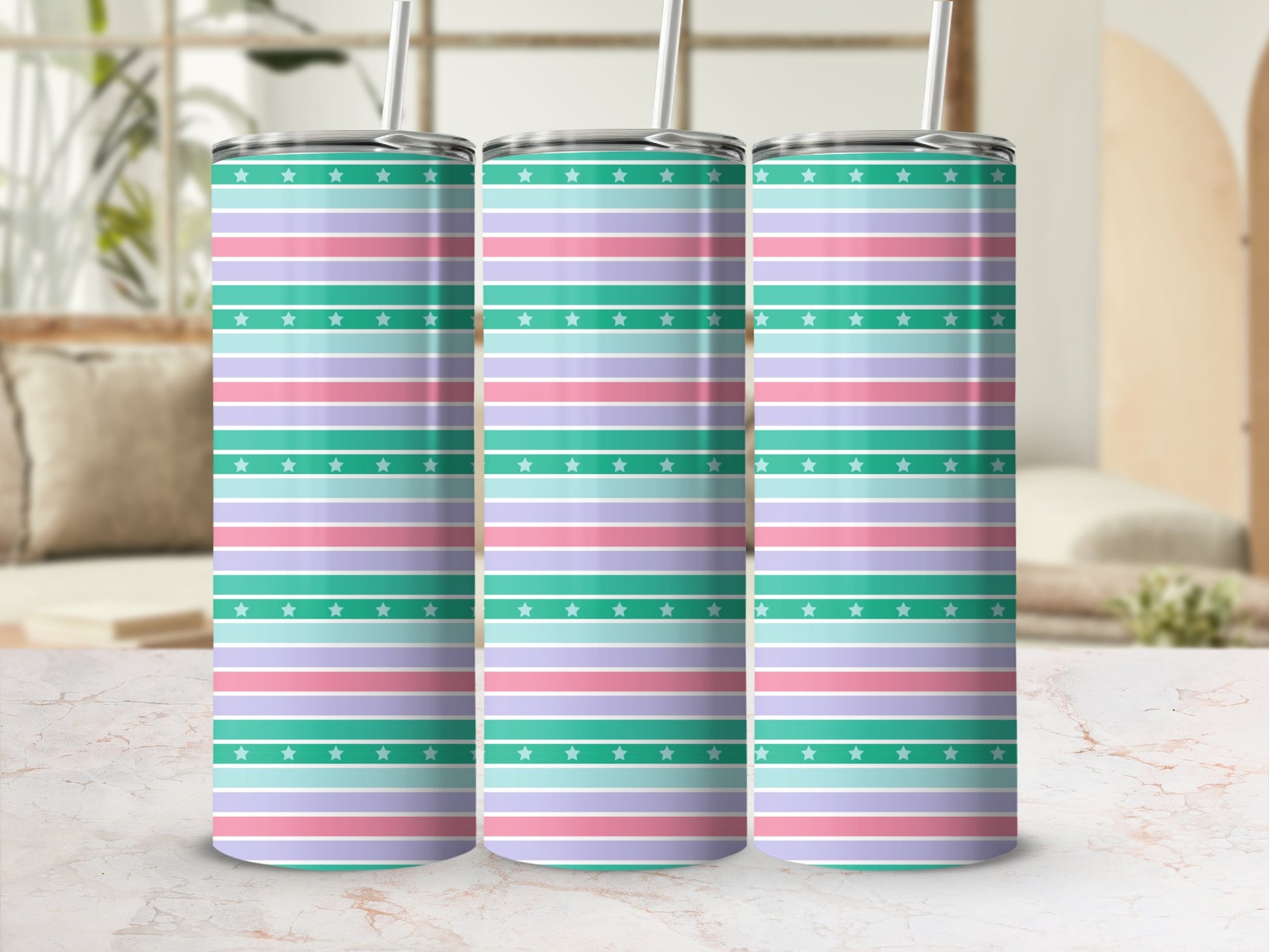 Three insulated tumblers with pastel stripes and stars.