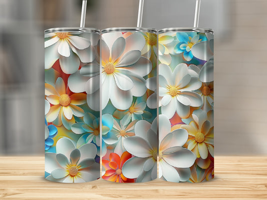 Three tumblers with vibrant floral patterns featuring white, yellow, and blue flowers.