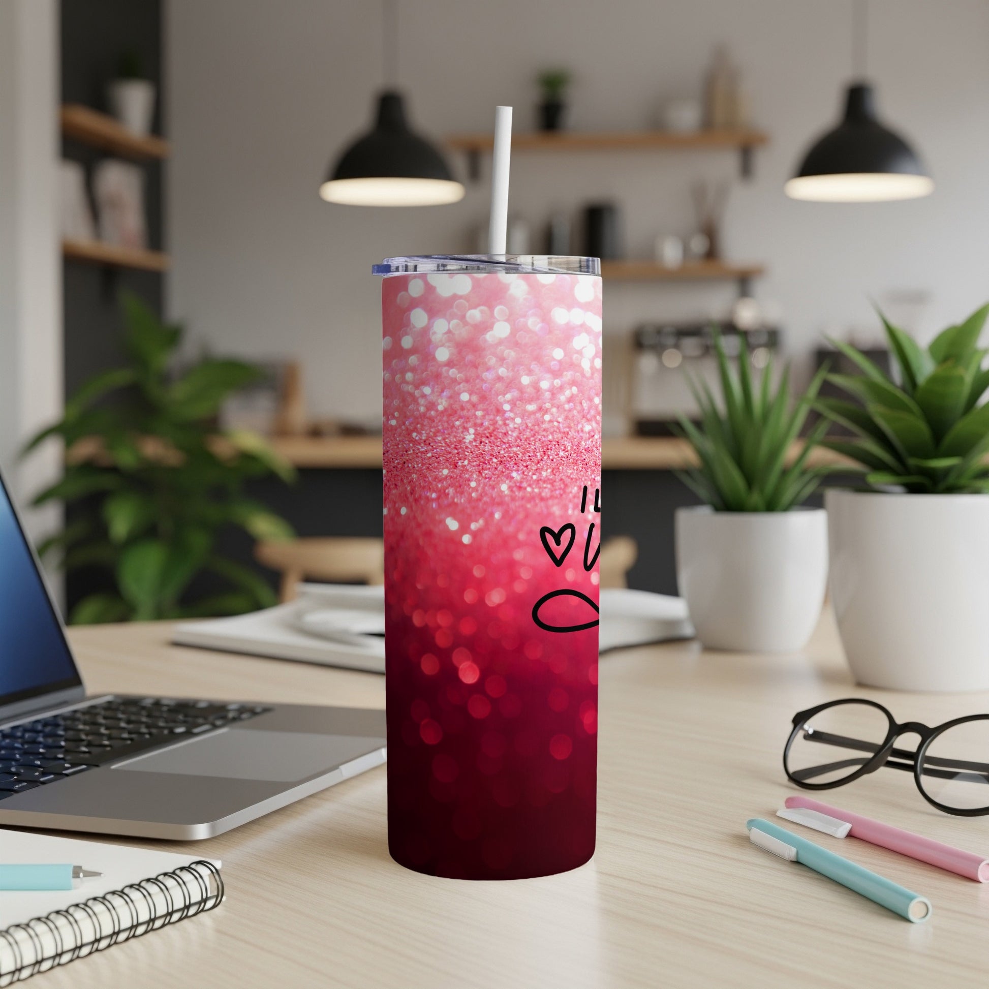 Red ombre glitter tumbler with "Love" handwritten on it, with a straw.