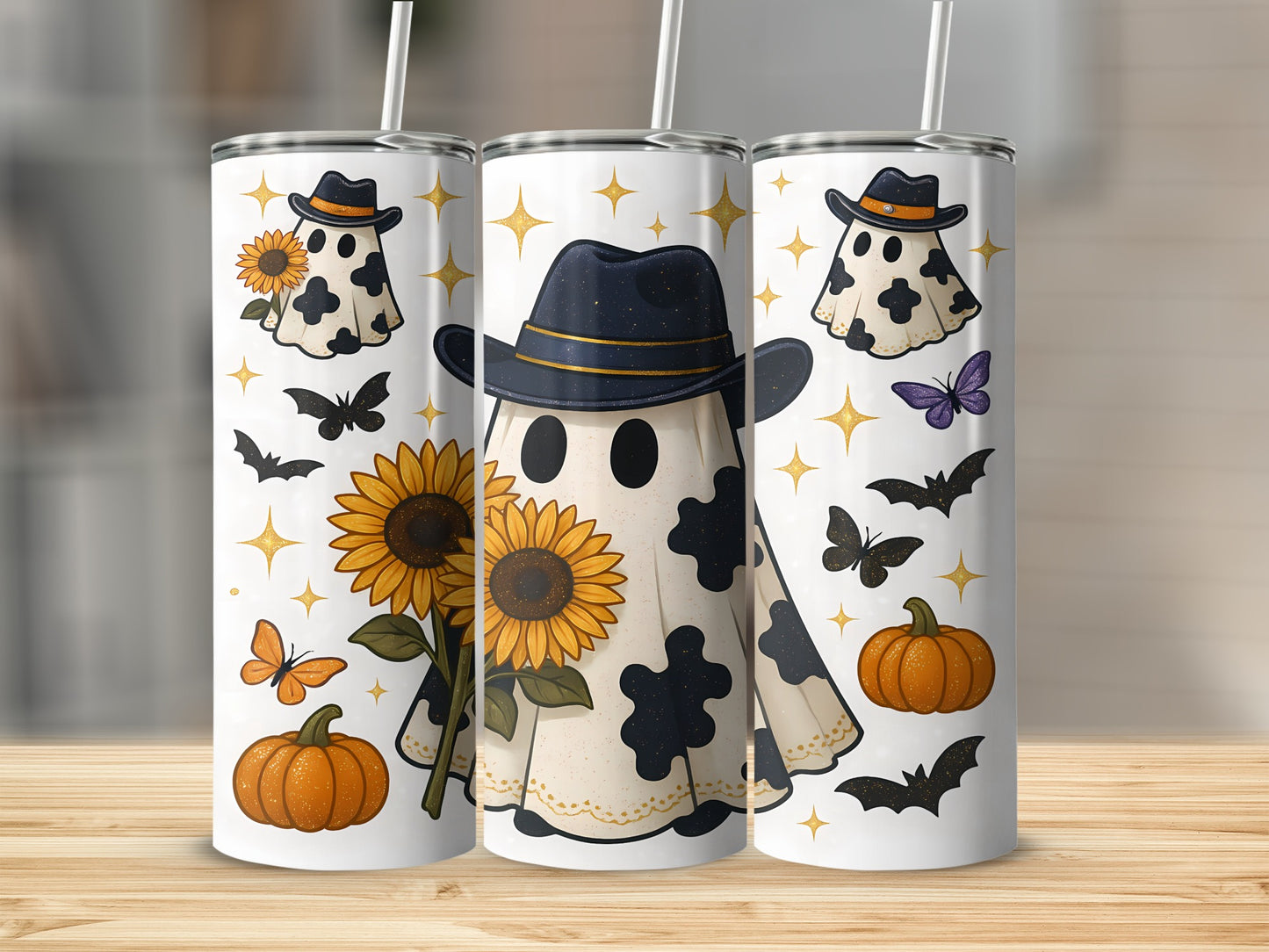 Three tumblers with ghost, sunflower, pumpkin, bat, and butterfly designs.