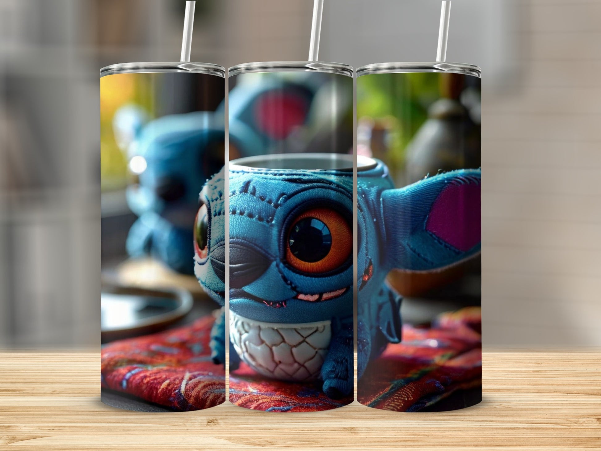 Three tumblers featuring Stitch character with orange eyes on a colorful fabric.