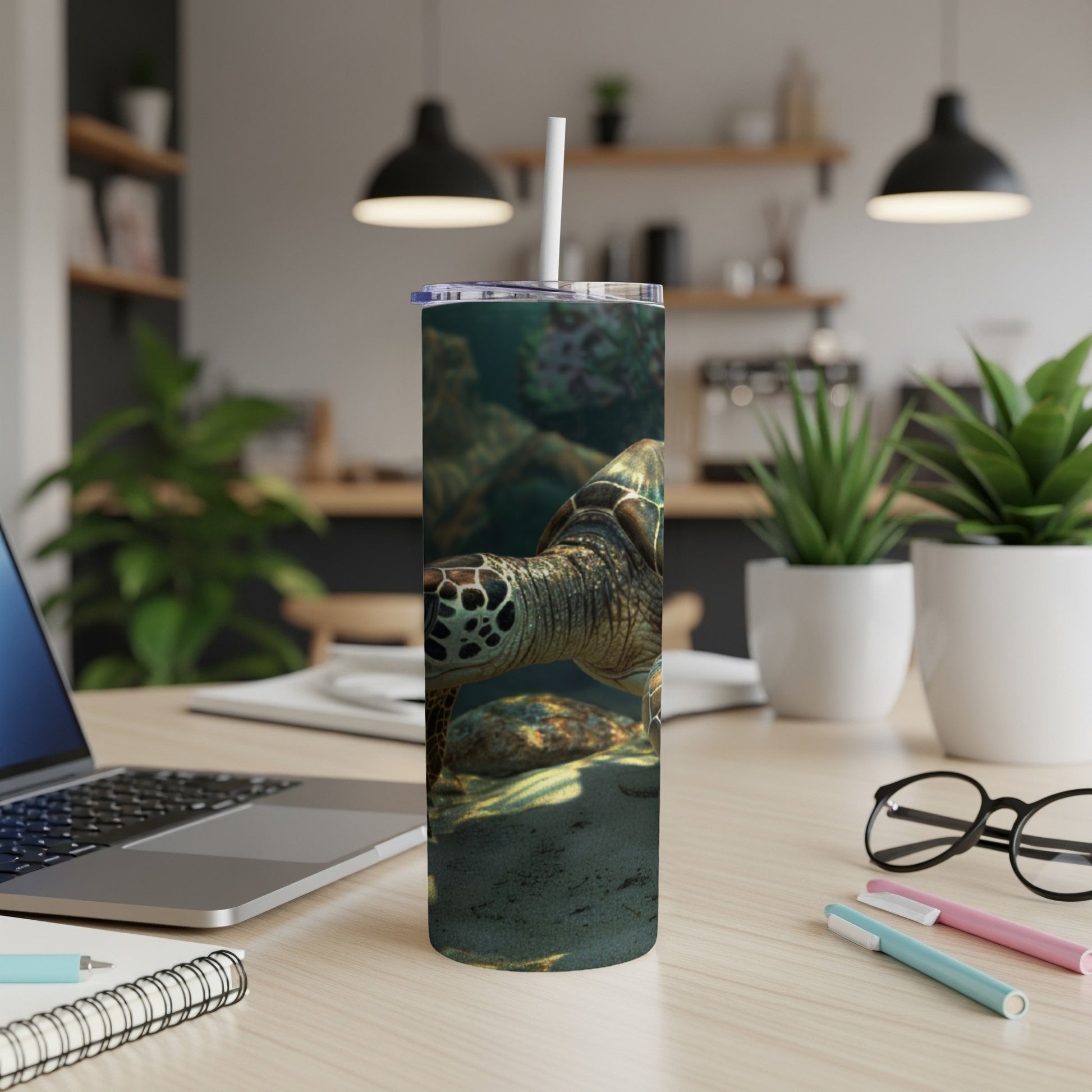 Sea turtle swimming underwater on a reusable tumbler.