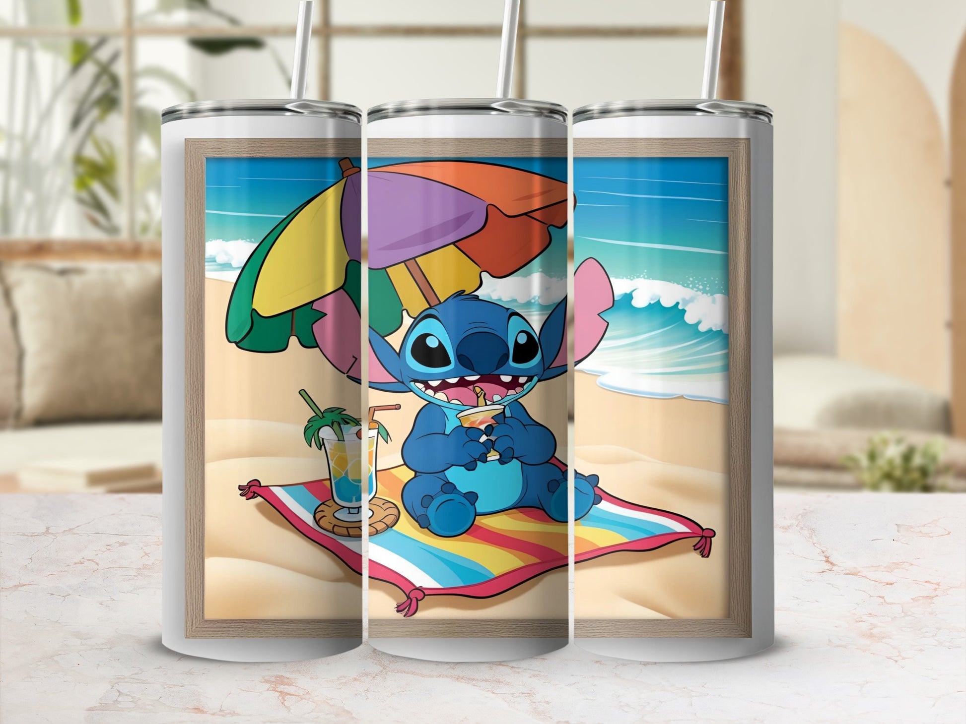 Stitch sitting on a colorful towel on the beach, drinking from a cocktail.