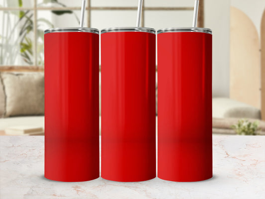 Three red tumblers with straws stand on a marble surface.
