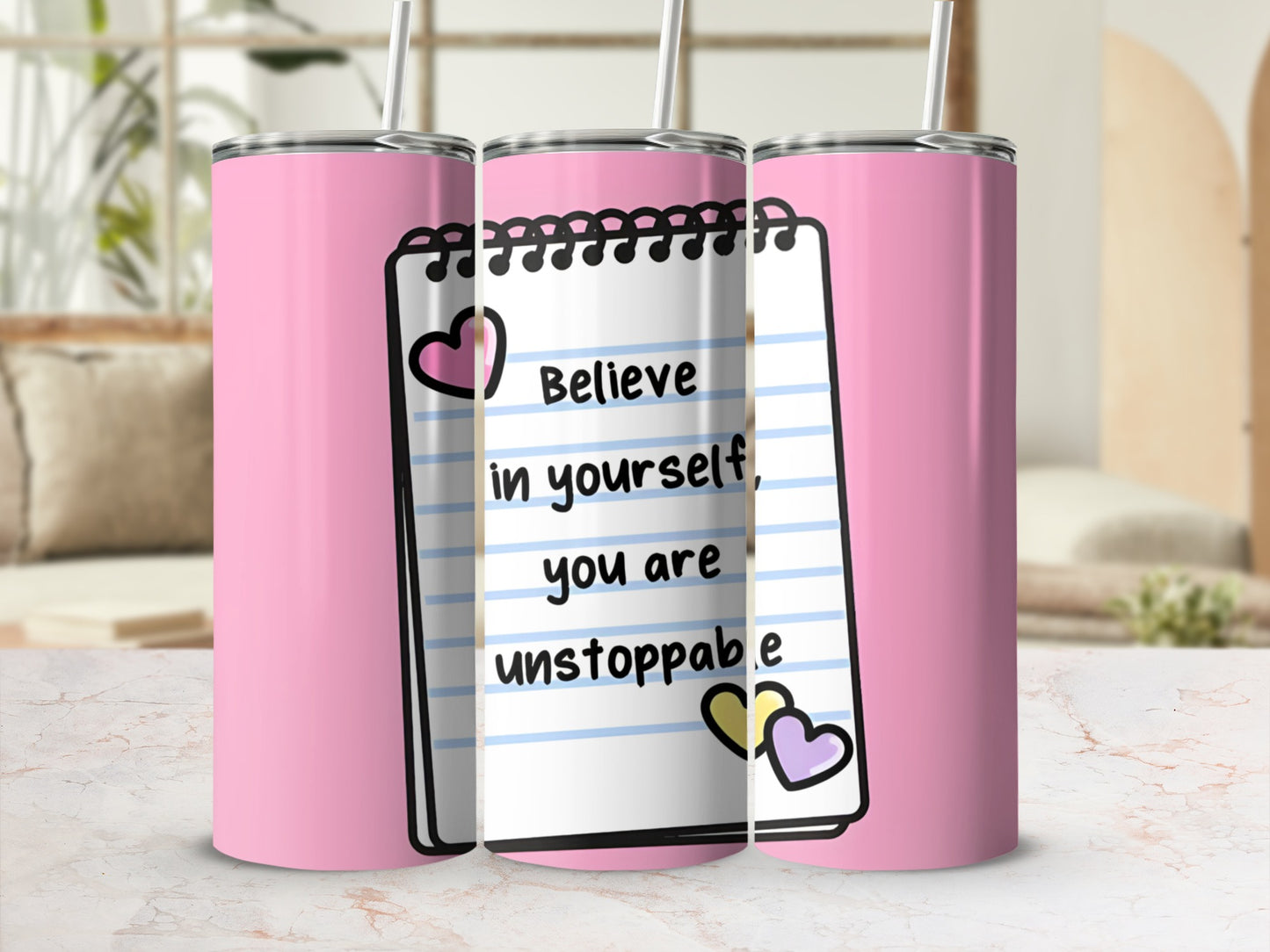 Pink tumbler with "Believe in yourself, you are unstoppable" written on notebook paper design.