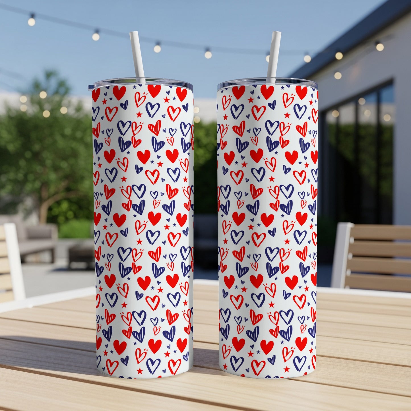 Two tumblers with red, white, and blue heart pattern on a table.