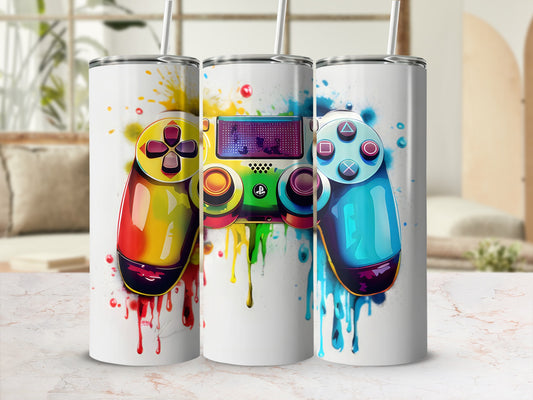 Three tumblers with colorful video game controller designs and paint splatters.