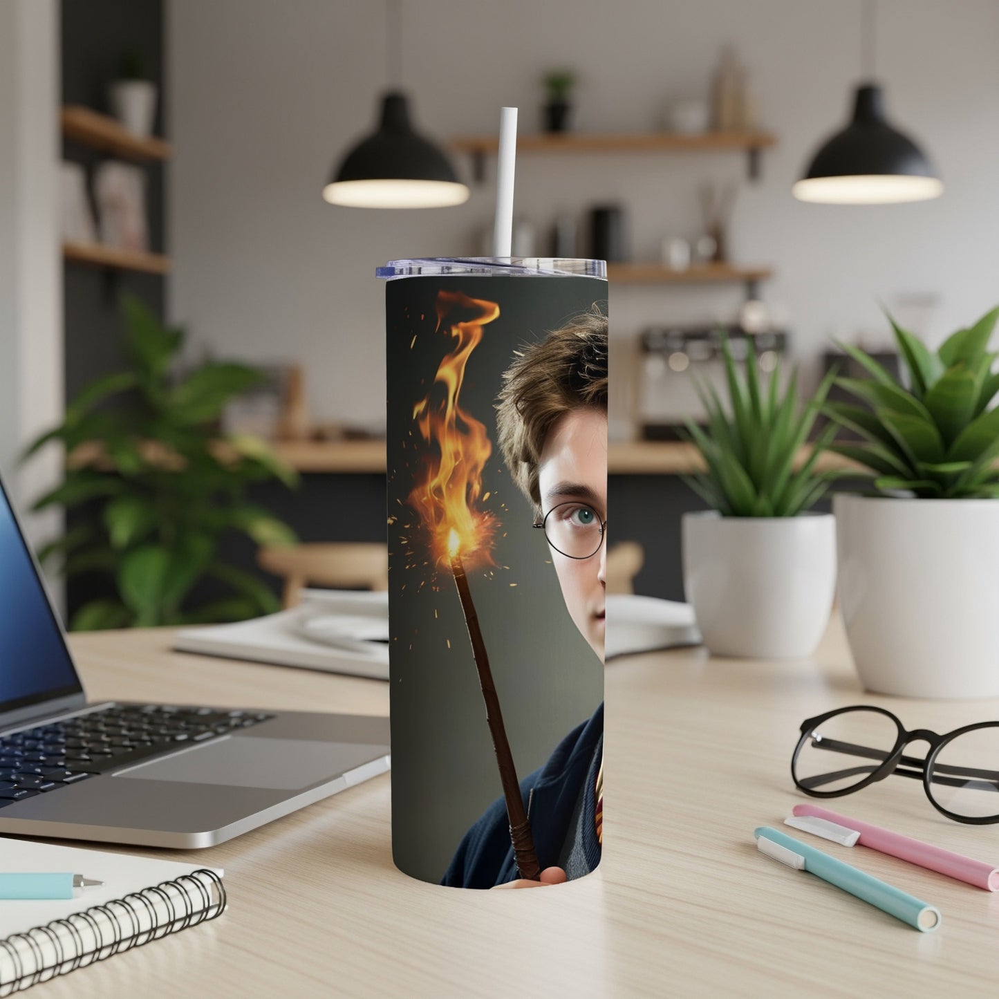 Harry Potter holding a flaming wand, close-up on a desk.