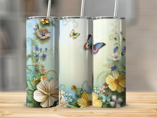 Three tumblers with floral and butterfly designs on a wooden surface.
