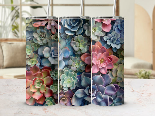Three tumblers with colorful succulent plant designs on a marble surface.