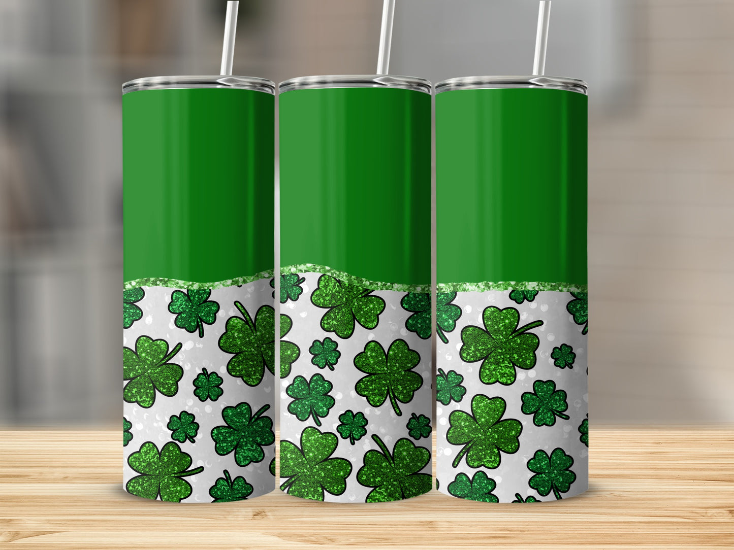 Three green tumblers with shamrock pattern and glitter accent.