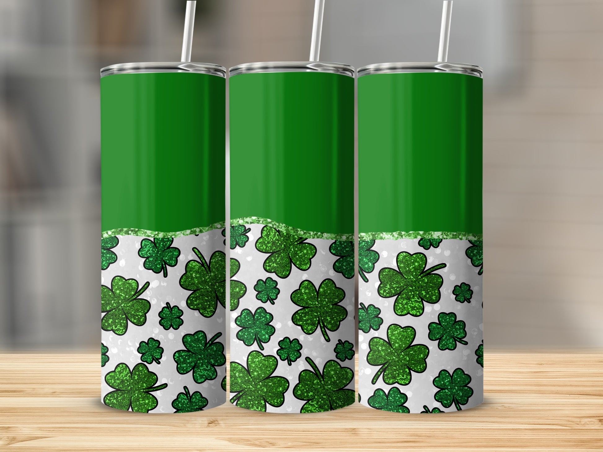 Three green tumblers with shamrock pattern and glitter accent.