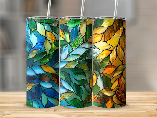 Three tumblers with stained glass leaf patterns in blue, green, and orange.