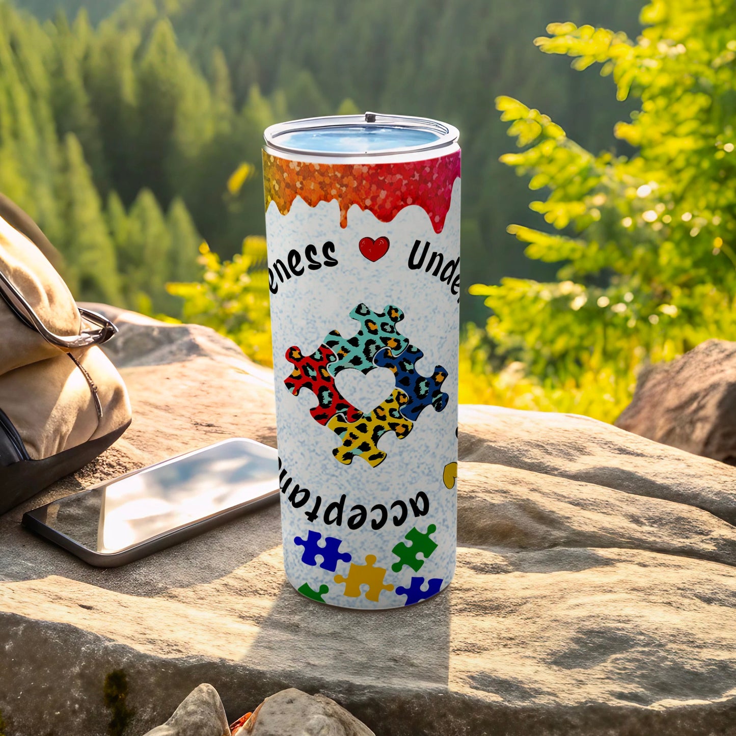 Rainbow puzzle pieces pattern on a tumbler with "Kindness Understand" text.