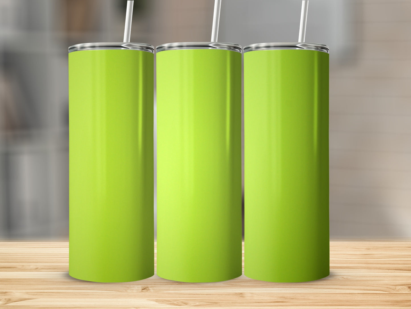 Three lime green tumblers with white straws on a wooden surface.