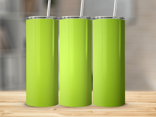 Three lime green tumblers with white straws on a wooden surface.