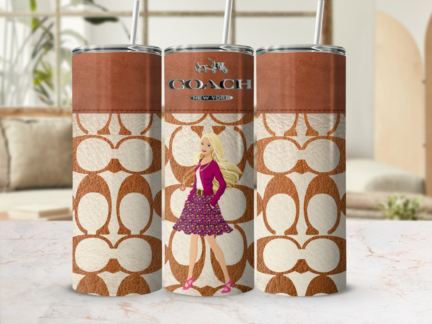 Three tumblers with Coach branding and Barbie artwork on a marbled surface.