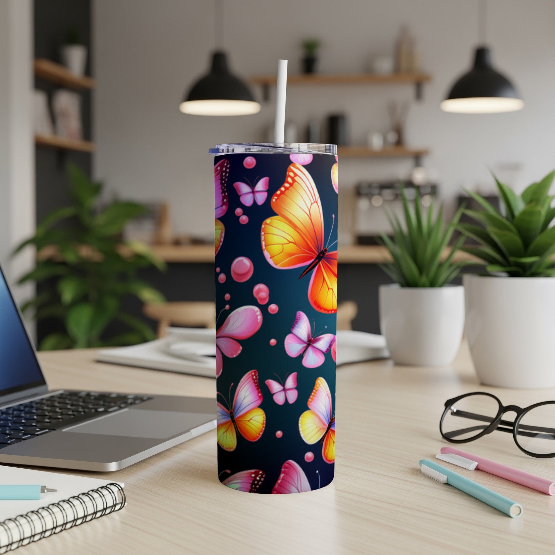 Tumbler with colorful butterflies and pink bubbles on dark background.