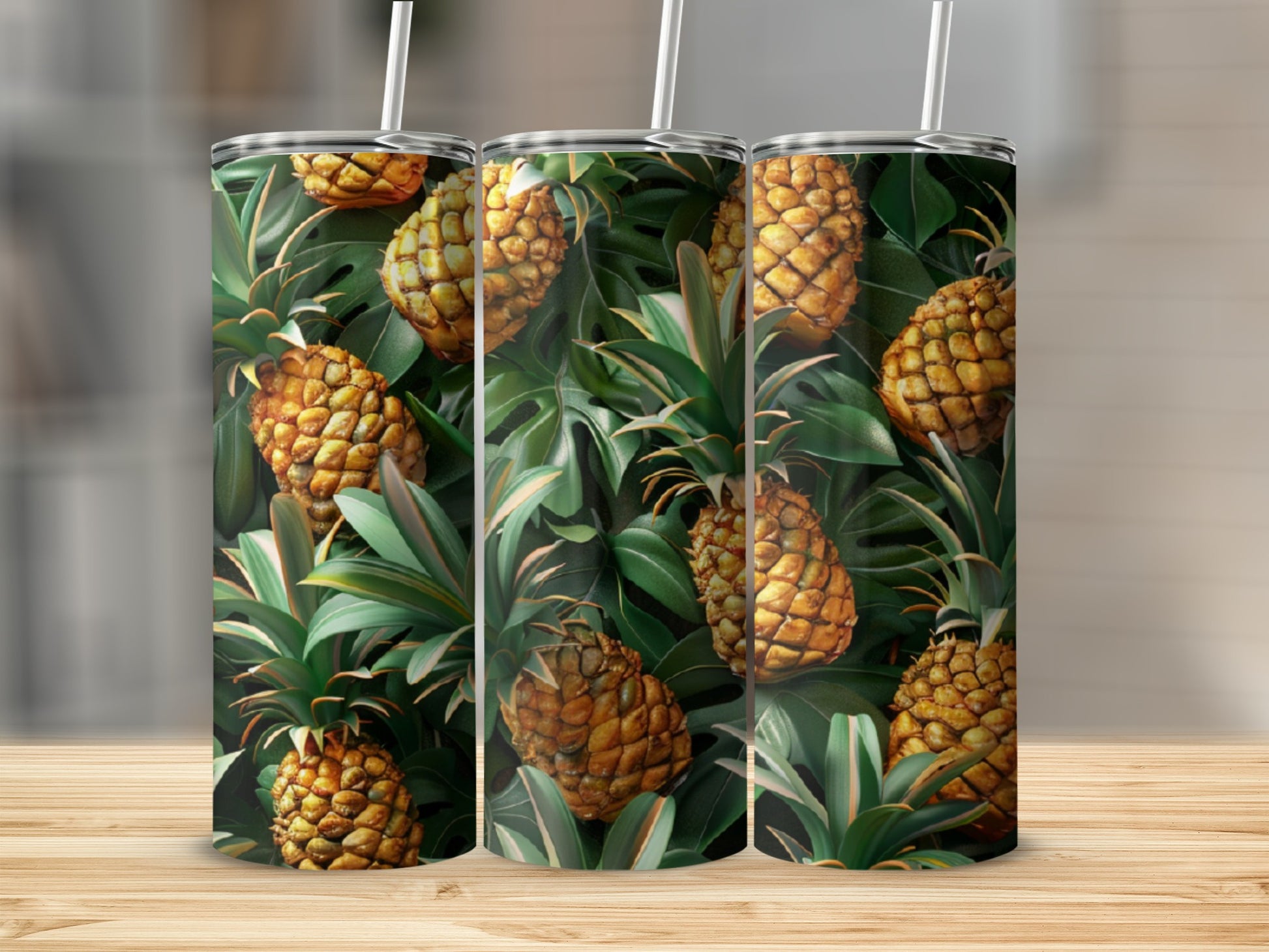 Pineapple and tropical leaf pattern on three tumblers with straws.