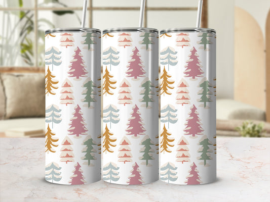 Tumbler with a repeating pattern of abstract pine trees in muted colors.