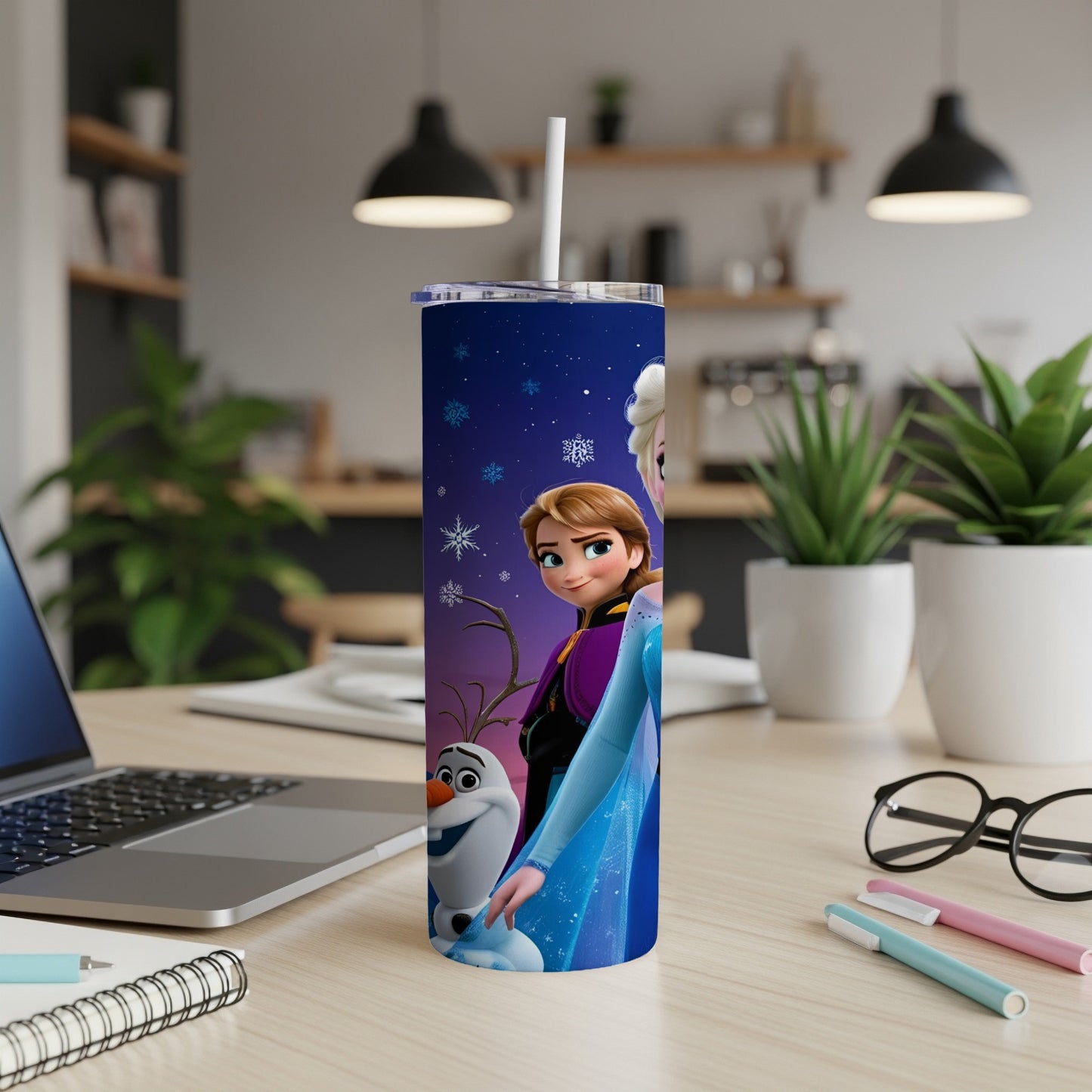 Elsa and Olaf from Frozen on a starry blue tumbler with a white straw.